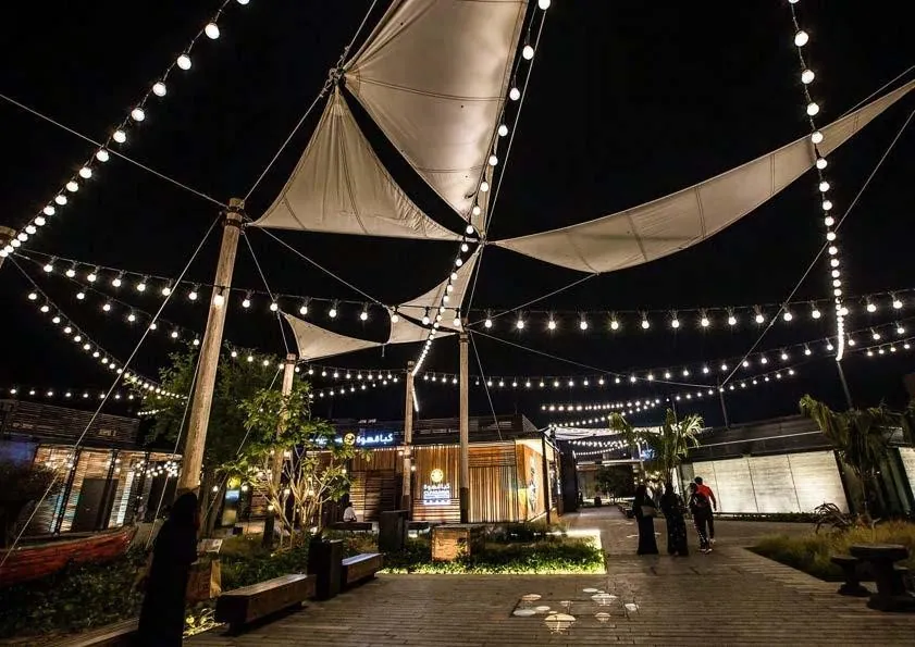Sail shades & festoon lights at dusk