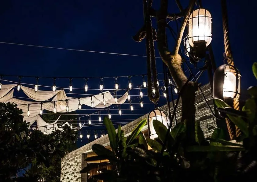 Hanging lanterns over waterfront dining