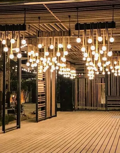 A cluster of caged pendants over a walkway